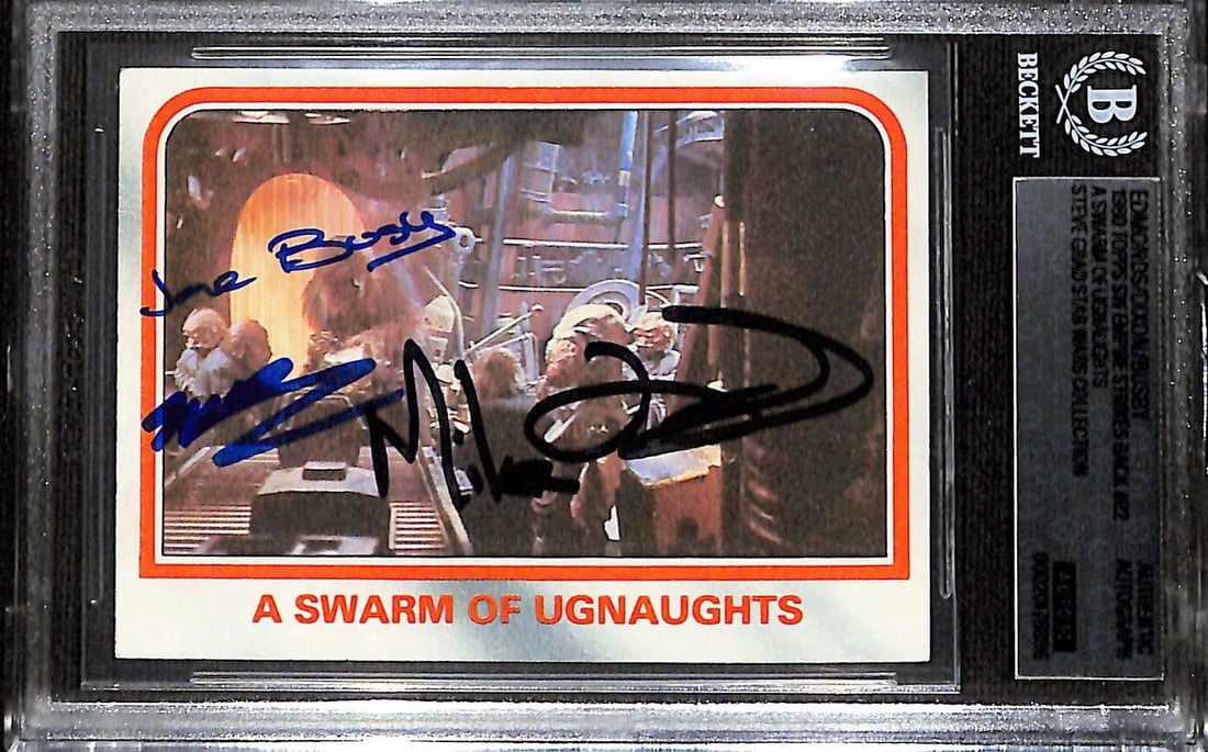 Beckett Authenticated Star Wars Topps Card Signed by Edmonds Busby Dixon: Beckett Authenticated Star Wars Topps Card Signed by Edmonds Busby Dixon This Star Wars: The Empire Strikes Back Topps trading card, titled "A Swarm of Ugnaughts" (#82), has been hand-signed on the fr