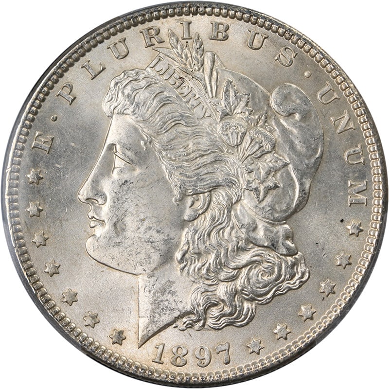 PCGS MS63 1897 Morgan Dollar Philadelphia Mint Silver Coin: PCGS MS63 1897 Morgan Dollar Philadelphia Mint Silver Coin This original 1897-P Morgan Silver Dollar is graded PCGS MS63 and features attractive eye appeal with strong luster and a well-defined strike
