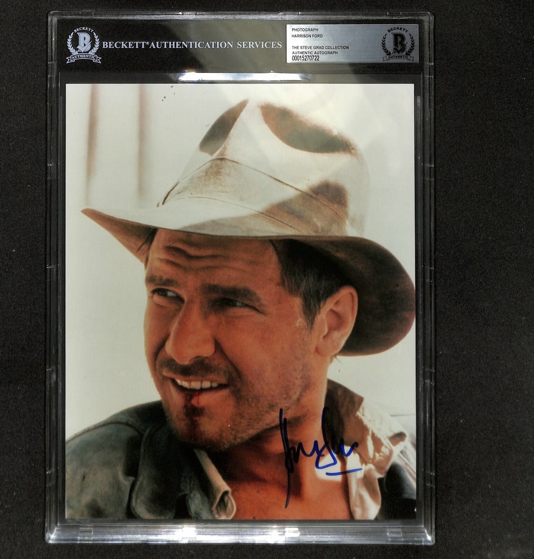 Harrison Ford Indiana Jones Signed 8x10 Photo Authentic Beckett: Harrison Ford Indiana Jones Signed 8x10 Photo Authentic Beckett This autographed 8x10 color photograph features Harrison Ford as Indiana Jones from the iconic film Raiders of the Lost Ark. Signed in b