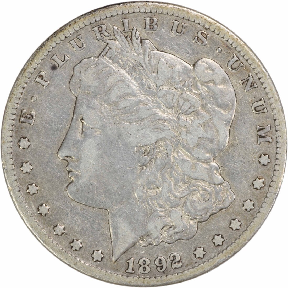 1892 CC Morgan Silver Dollar VF Uncertified 90% Silver Coin: 1892 CC Morgan Silver Dollar VF Uncertified 90% Silver Coin This 1892-CC Morgan Silver Dollar is a remarkable piece of numismatic history. It features the classic design by George T. Morgan, showcasin