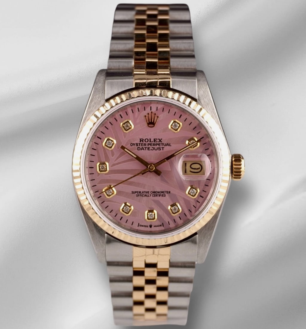 Rolex Datejust 16013 Pink Palm Dial Fluted Bezel Jubilee Bracelet: Rolex Datejust 16013 Pink Palm Dial Fluted Bezel Jubilee Bracelet This men's Rolex Datejust features an aftermarket pink palm motif dial with yellow gold diamond markers, complemented by a fluted beze