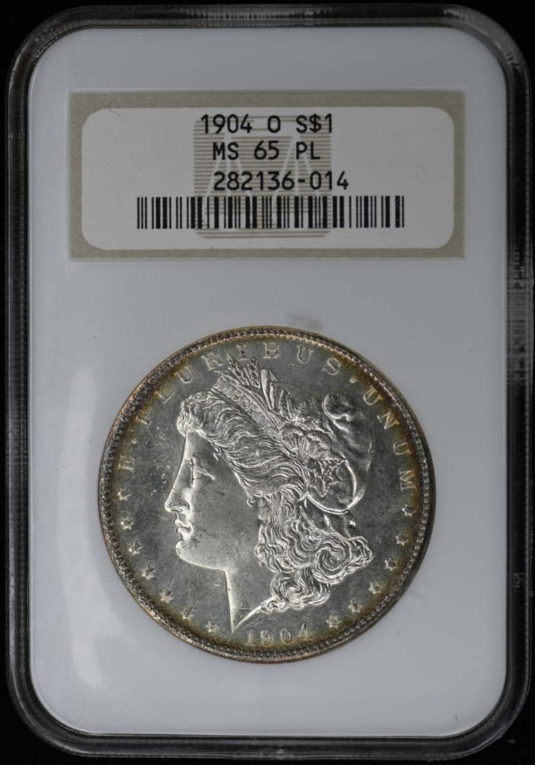 1904-O Morgan Dollar NGC MS65PL Proof-Like Uncirculated: 1904-O Morgan Dollar NGC MS65PL Proof-Like Uncirculated This exquisite 1904-O Morgan Dollar is certified by NGC with a grade of MS65PL, indicating its uncirculated condition and proof-like strike. Min