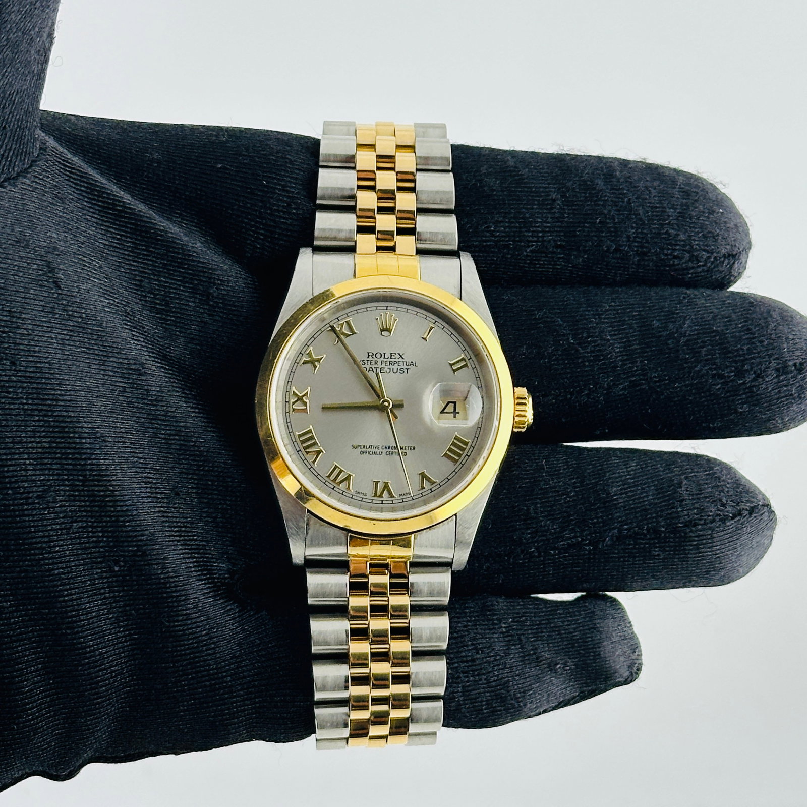 Rolex Datejust Ref 16203 Watch with Champagne Roman Dial D Link Jubilee Bracelet: Rolex Datejust Ref 16203 Watch with Champagne Roman Dial D Link Jubilee Bracelet This Rolex Datejust features a champagne Roman stick dial, a smooth bezel, and is fitted with a D-Link Jubilee bracelet