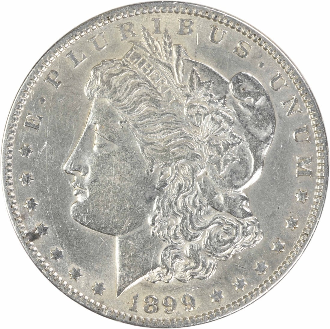 1899 AU Morgan Silver Dollar Philadelphia Uncertified: 1899 AU Morgan Silver Dollar Philadelphia Uncertified 1899 Morgan Silver Dollar in AU grade, circulated condition. This United States coin is an uncertified Morgan dollar with no mint mark, struck in 
