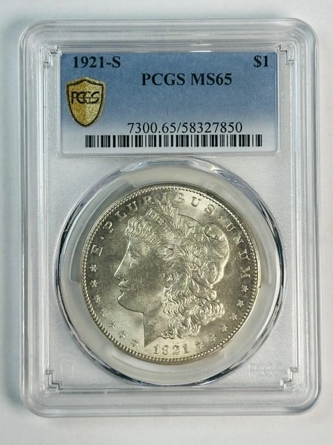 PCGS MS-65 1921-S Morgan Silver Dollar: PCGS MS-65 1921-S Morgan Silver Dollar This 1921 Morgan Silver Dollar is certified by PCGS with a grade of MS 65. Struck in San Francisco, it features a white appearance and is composed of silver. Thi