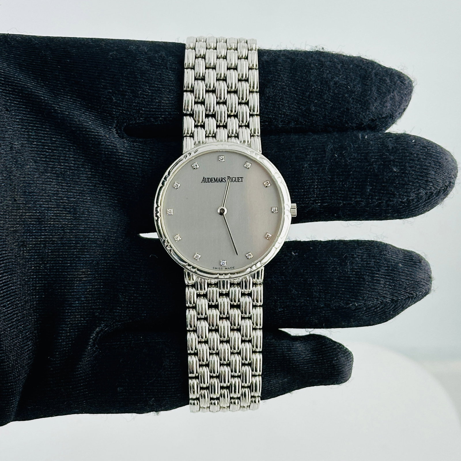 White Gold Mesh Bracelet Watch with Silver Diamond Dial by Audemars Piguet: White Gold Mesh Bracelet Watch with Silver Diamond Dial by Audemars Piguet This unisex Audemars Piguet watch features a silver dial accented with diamond details. It is equipped with a fixed bezel and