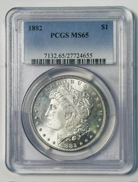 PCGS MS65 1882 Morgan Silver Dollar Philadelphia: PCGS MS65 1882 Morgan Silver Dollar Philadelphia This 1882 Morgan Silver Dollar was minted in Philadelphia and is graded MS-65 by PCGS. Composed of silver, it is a pre-owned collectible coin from the 