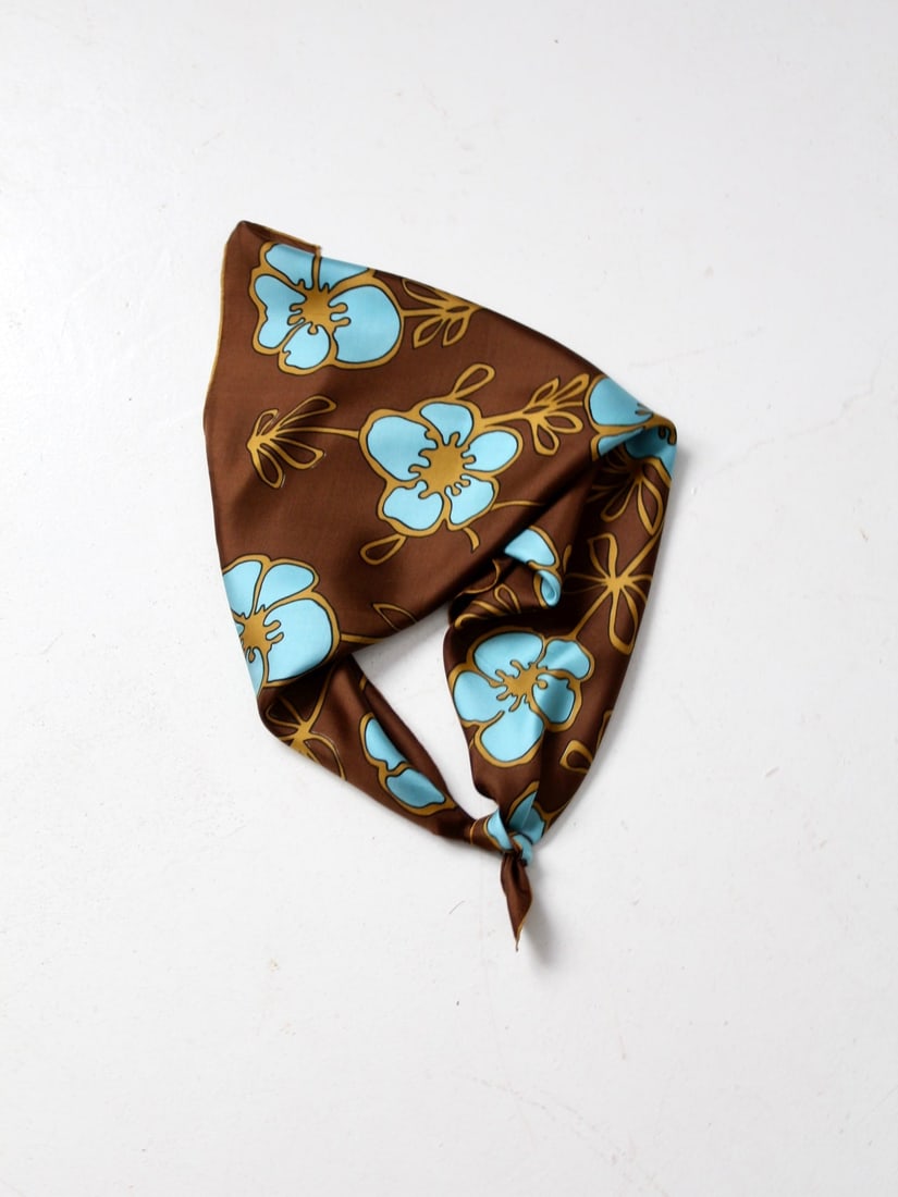 Vintage 70s Japanese Silk Scarf Blue Gold Floral Print: Vintage 70s Japanese Silk Scarf Blue Gold Floral Print This vintage silk scarf from 1978 showcases a striking mod blue and gold floral print set against a luxurious brown background. Perfect for enhan