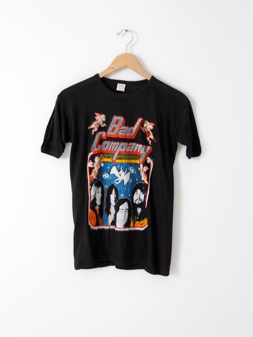 Vintage Bad Company T-Shirt 1979 Desolation Angels Album Cotton Tee: Vintage Bad Company T-Shirt 1979 Desolation Angels Album Cotton Tee This vintage Bad Company band t-shirt is a nostalgic piece from the 1979-1980 Desolation Angels album/tour era. Made of 100% black c