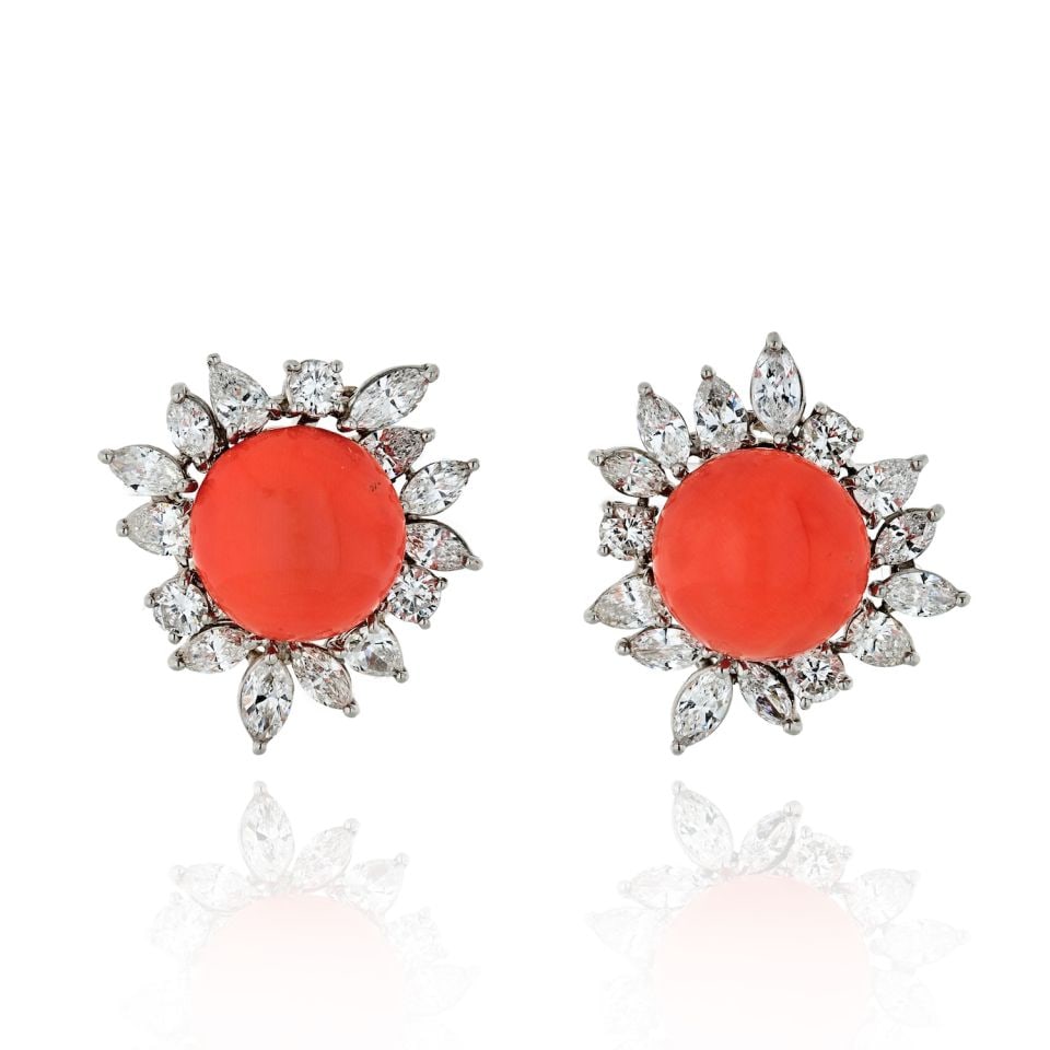 1960s Platinum Earrings With 8 Carat Diamond and Coral Accents: 1960s Platinum Earrings With 8 Carat Diamond and Coral Accents These circa 1960s earrings are crafted from platinum and feature a sophisticated arrangement of pear, marquise, and round diamonds encirc
