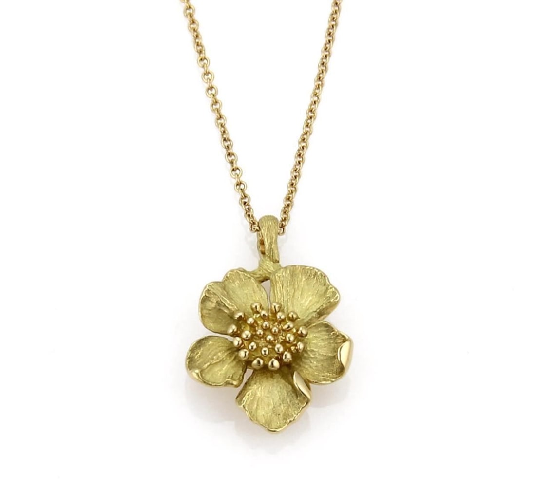 Tiffany & Co. Dogwood Floral Pendant Necklace in 18k Yellow Gold 16": Tiffany & Co. Dogwood Floral Pendant Necklace in 18k Yellow Gold 16" A Tiffany & Co. Dogwood floral pendant necklace crafted in 18k yellow gold. The necklace features a sculptural dogwood flower penda