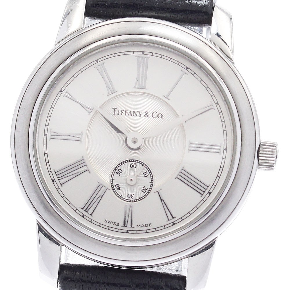 Tiffany Mark Round quartz ladies watch small seconds leather band: Tiffany Mark Round quartz ladies watch small seconds leather band This Tiffany & Co. Mark Round women's wristwatch features a stainless steel case paired with a leather band and a silver dial. The wat
