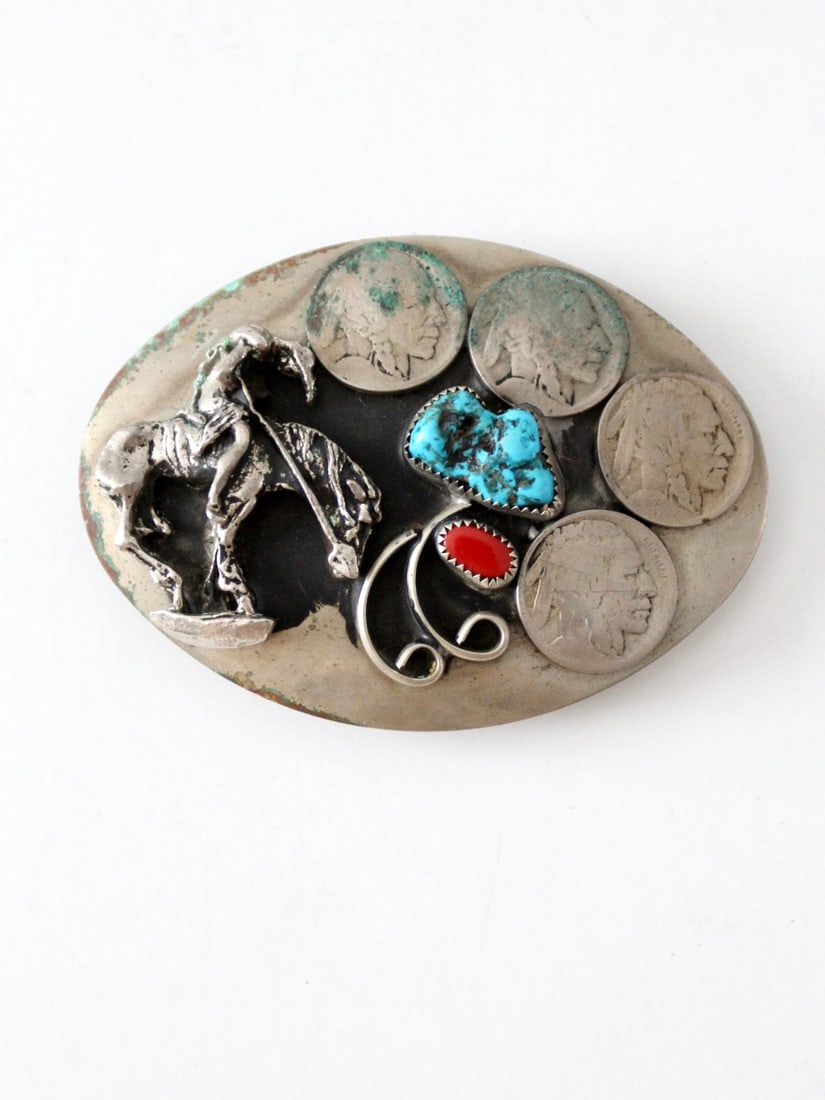 Vintage Western Buckle with Indian Head Coins and Turquoise: Vintage Western Buckle with Indian Head Coins and Turquoise This vintage western belt buckle showcases a striking silver tone finish accented by four Indian head coins and vibrant insets of blue and r