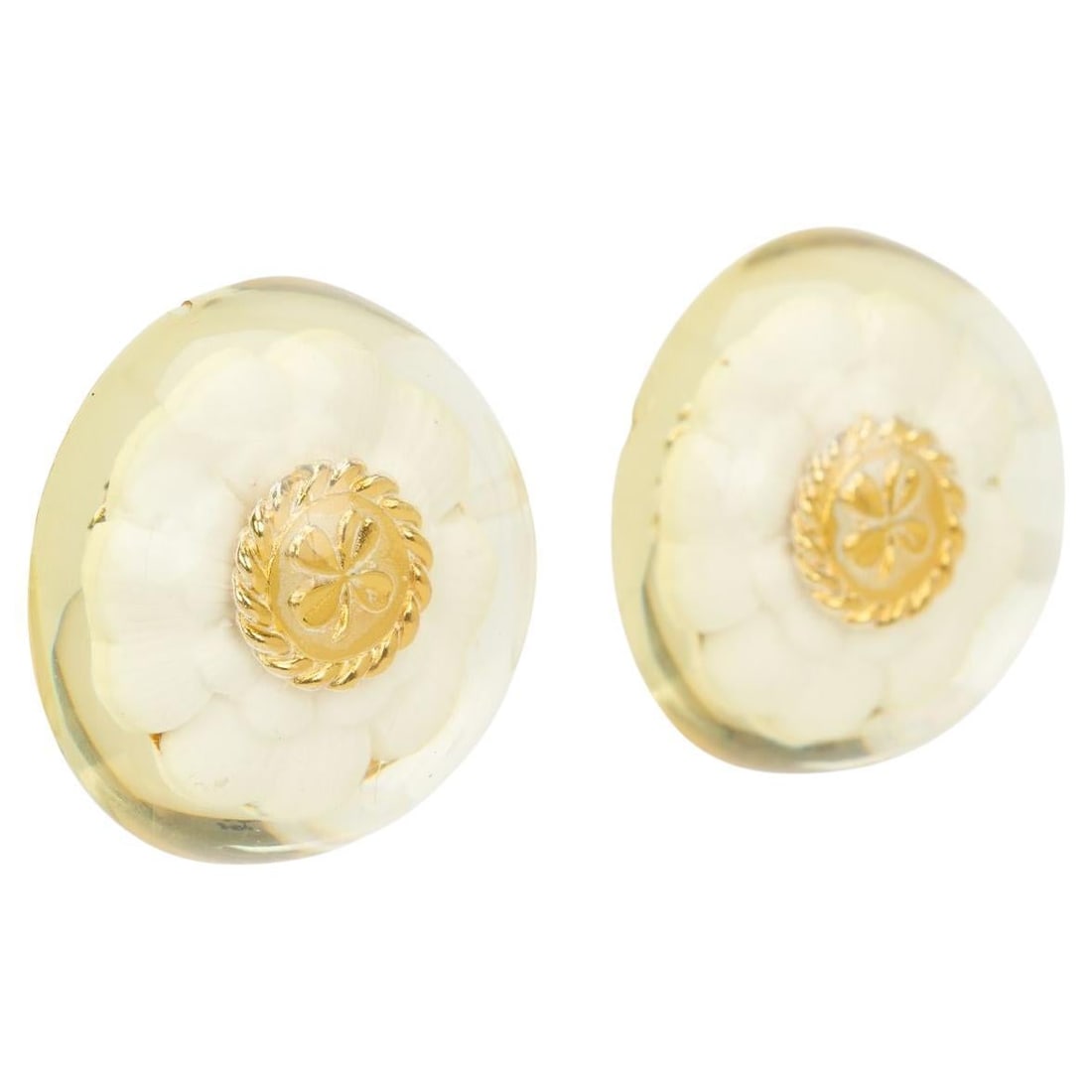 Vintage Chanel Camelia Clip On Lucite Earrings: Vintage Chanel Camelia Clip On Lucite Earrings These vintage Chanel earrings from the 1970s feature a Camelia flower design crafted in lucite resin with gold-tone accents. The decorative flower is set