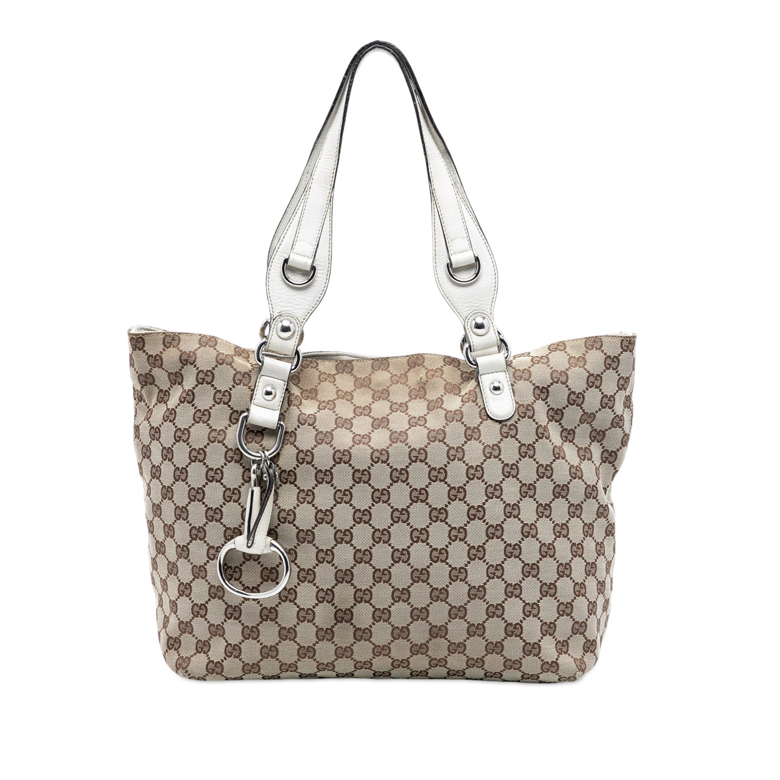 Gucci Beige Canvas Tote with Leather Trim and Bit Detail: Gucci Beige Canvas Tote with Leather Trim and Bit Detail This Gucci Medium GG Canvas Icon Bit Tote features a beige canvas body with leather trim and flat leather straps. The bag has an open top with 