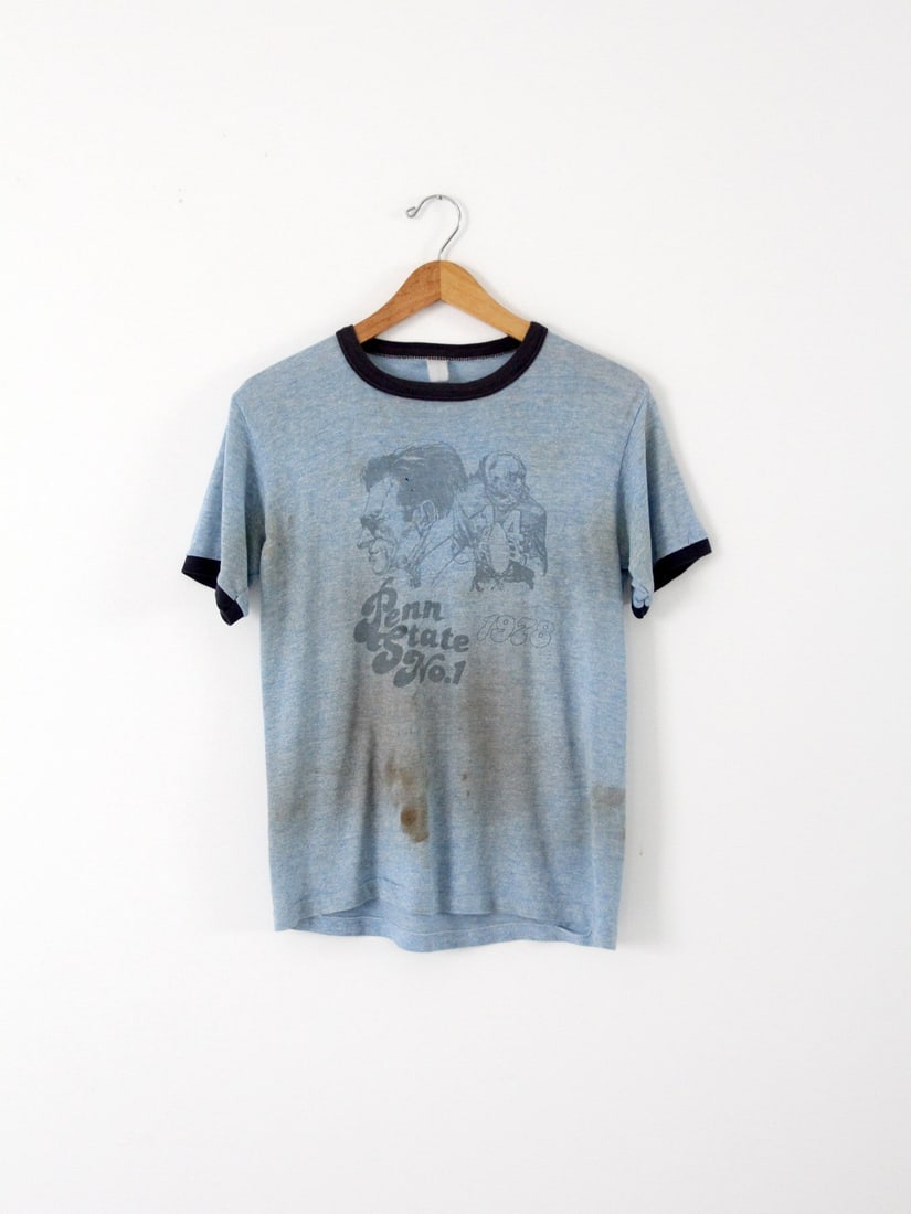 Vintage 1978 Penn State Football T-Shirt Joe Paterno and Chuck Fusina Graphic: Vintage 1978 Penn State Football T-Shirt Joe Paterno and Chuck Fusina Graphic This vintage 1978 Penn State football t-shirt is a unique piece from our Stylist's Collection. Crafted from a soft, worn-i