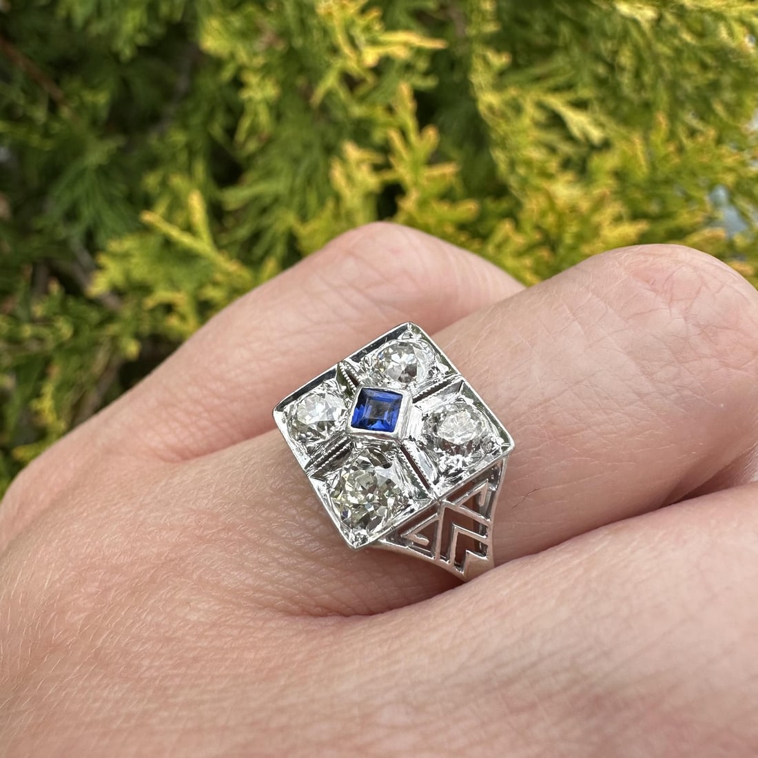 Antique Platinum Cocktail Ring with Sapphire and 4 Old Mine Cut Diamonds: Antique Platinum Cocktail Ring with Sapphire and 4 Old Mine Cut Diamonds This antique cocktail ring features a solid platinum top with a 13-14k white gold shank. The centerpiece includes four natural 