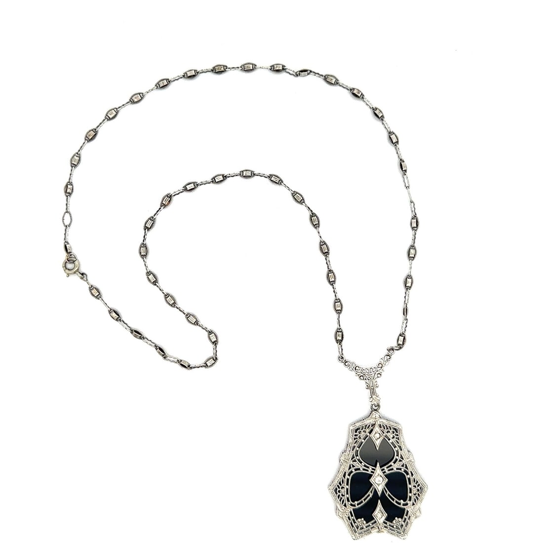 Art Deco onyx diamond filigree pendant 16 inch white gold chain: Art Deco onyx diamond filigree pendant 16 inch white gold chain This antique Art Deco necklace features a custom-cut, natural black onyx pendant accented by three old single and old mine cut natural d