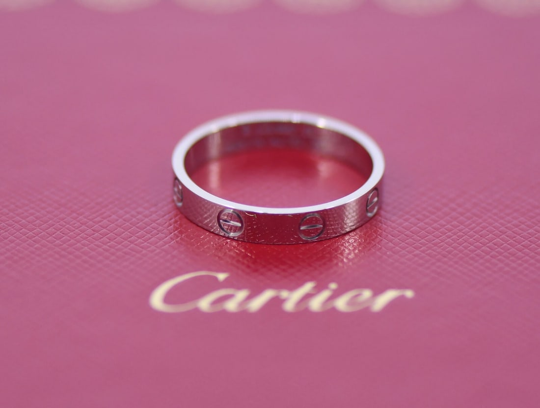 Cartier 18K White Gold Love Ring Size 8.75 with Service Receipt: Cartier 18K White Gold Love Ring Size 8.75 with Service Receipt This exquisite Cartier Love Ring is expertly crafted from 18K white gold, embodying the timeless theme of love. The ring is designed in 
