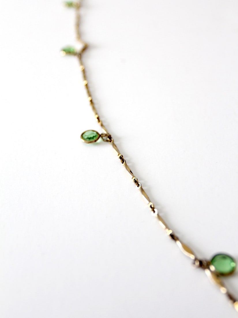 Vintage Gold Link Chain Necklace with Pale Green Stones 50in: Vintage Gold Link Chain Necklace with Pale Green Stones 50in This exquisite vintage gold link chain necklace showcases a series of delicate translucent pale green stones elegantly set as inset drops. 