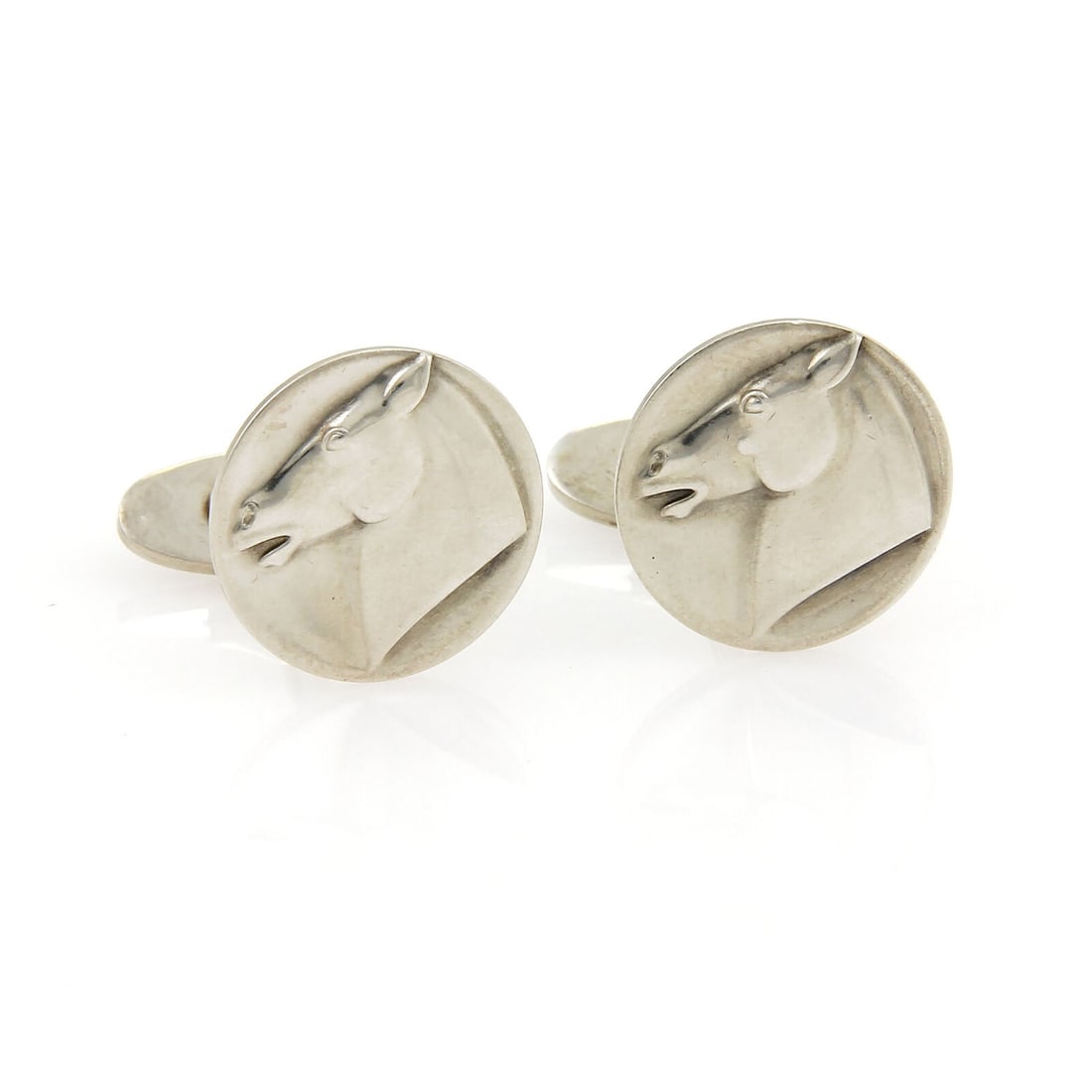 Georg Jensen Horse Motif Sterling Silver Round Stud Cufflinks: Georg Jensen Horse Motif Sterling Silver Round Stud Cufflinks Sterling silver cufflinks in a round top stud design featuring an elegant horse motif and refined sculptural detailing. Marked with Georg 