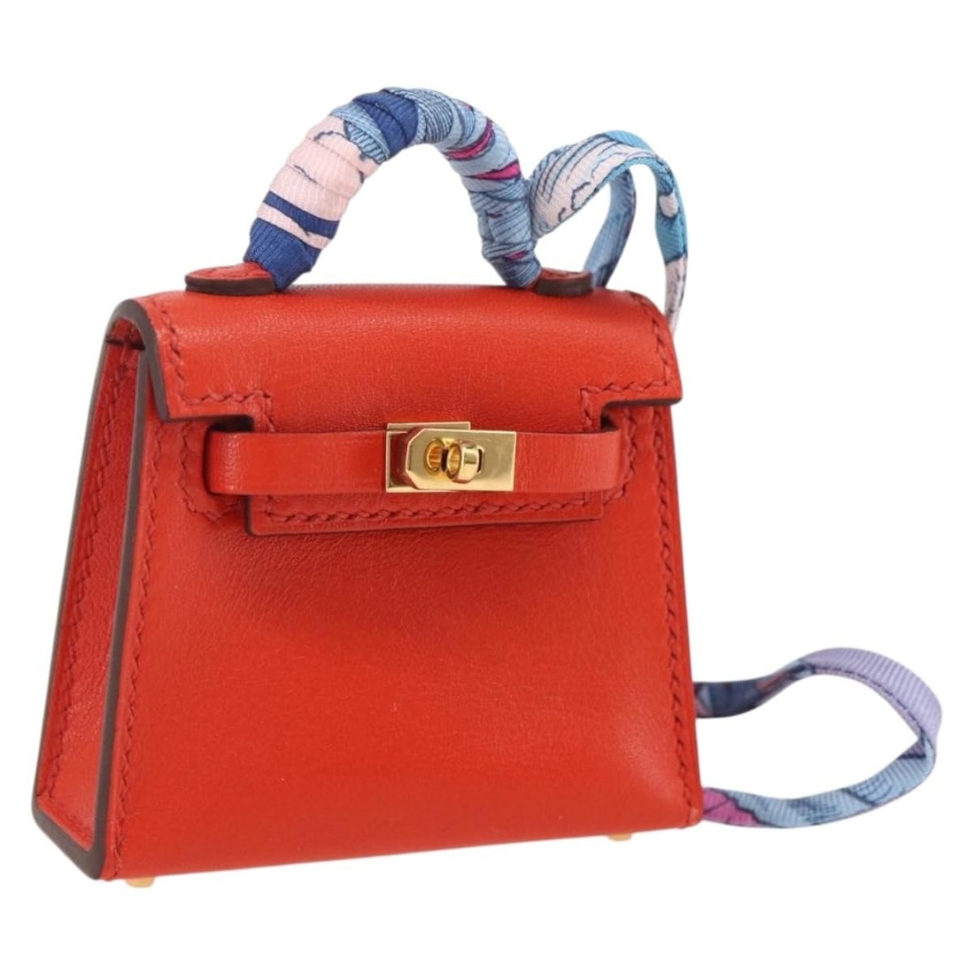 Hermes Kelly Micro Twilly Orange Leather Bag Charm Accessory: Hermes Kelly Micro Twilly Orange Leather Bag Charm Accessory This HERMES Micro Kelly Twilly bag charm is crafted from orange leather and designed to add a stylish accent to your handbag. The charm is 