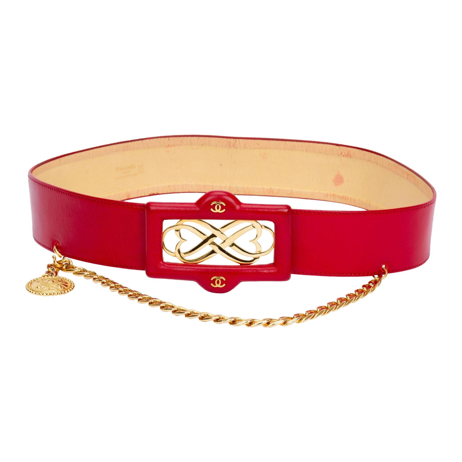 Chanel 80s Red Leather Belt with Chain Drop and Coin Pendant: Chanel 80s Red Leather Belt with Chain Drop and Coin Pendant Elevate your style with this exquisite Chanel 80s red leather belt, featuring a stunning logo buckle and a stylish chain drop adorned with 