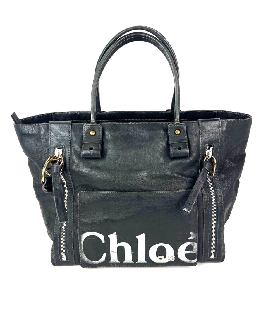 Eclipse Large Black Leather Tote With Logo Applique And Brand Card By Chloe: Eclipse Large Black Leather Tote With Logo Applique And Brand Card By Chloe This Chloe Eclipse tote features a black distressed leather exterior with applique logo embellishments. The large, rectangul