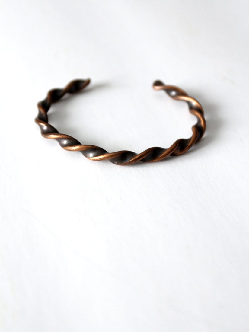 1970s Vintage Copper Cuff Bracelet with Twisted Braid Design: 1970s Vintage Copper Cuff Bracelet with Twisted Braid Design Embrace timeless style with this vintage copper cuff bracelet from the 1970s. It showcases a chic twisted braid design, adding a touch of e