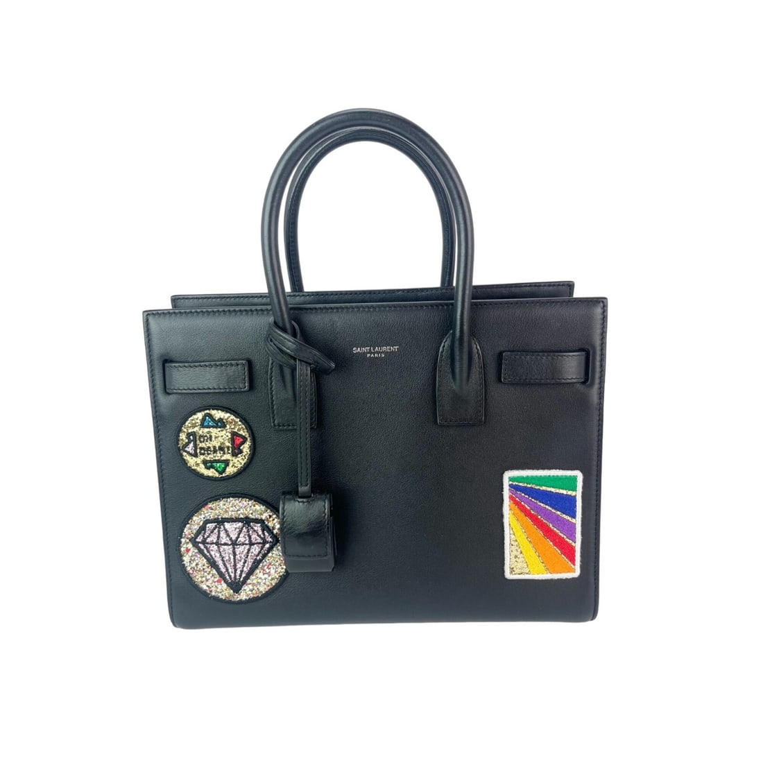 Saint Laurent Sac De Jour Tote Black Leather Bag with Applique Patches: Saint Laurent Sac De Jour Tote Black Leather Bag with Applique Patches Introducing the Saint Laurent Sac De Jour Embellished Patches Shoulder Bag, a chic and versatile accessory crafted from premium b