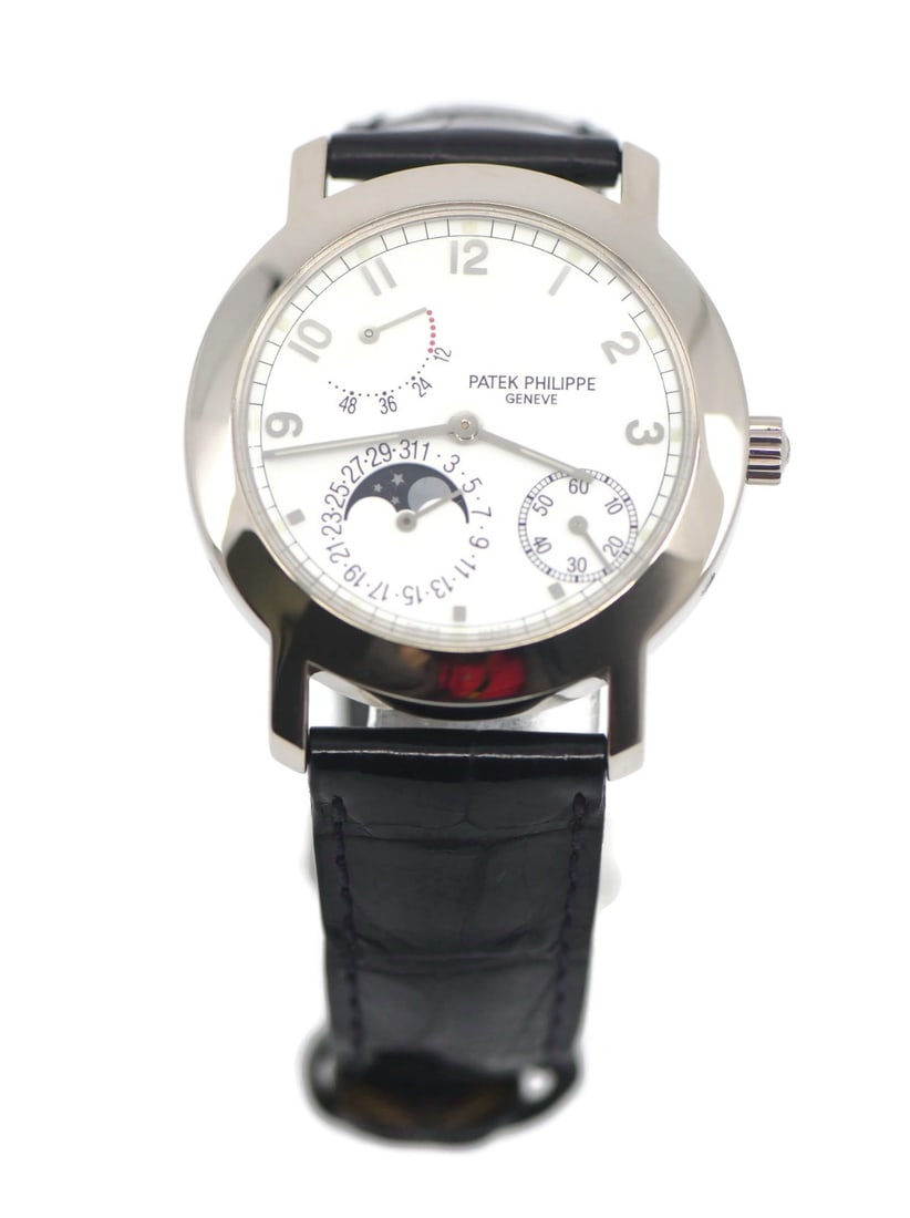 Patek Philippe Complications 5055G White Gold Wristwatch: Patek Philippe Complications 5055G White Gold Wristwatch This Patek Philippe Complications wristwatch, reference 5055G, features a 36mm round case crafted from 18K white gold. The watch has a white an
