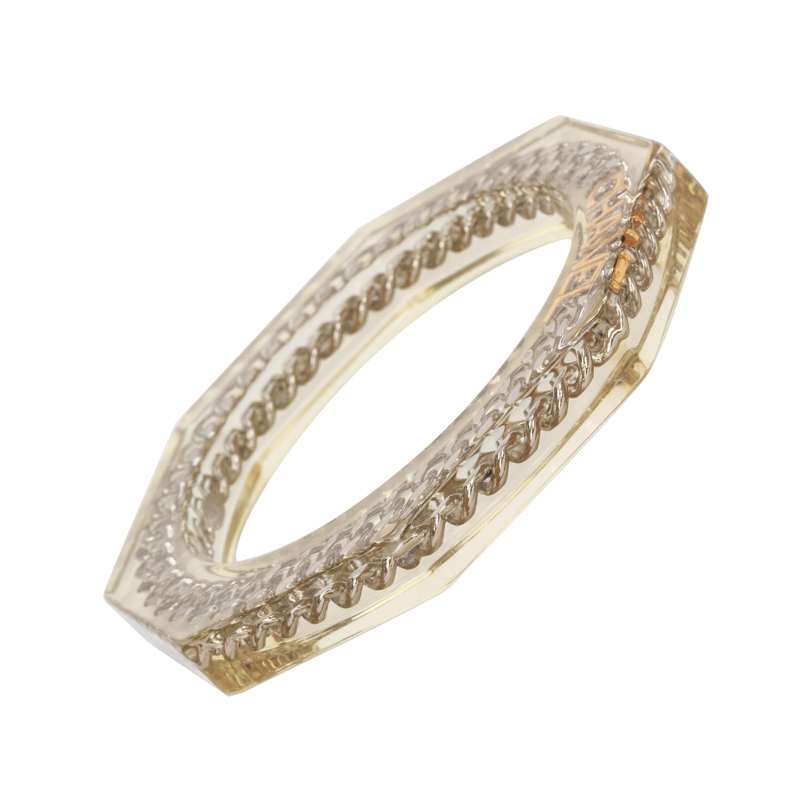 Chanel Spring 97 Lucite Octagon Bracelet with Silver Chain and Gold Logo: Chanel Spring 97 Lucite Octagon Bracelet with Silver Chain and Gold Logo This Chanel octagonal bracelet from the Spring 1997 collection features a lucite body accented with a silver-tone chain and a g