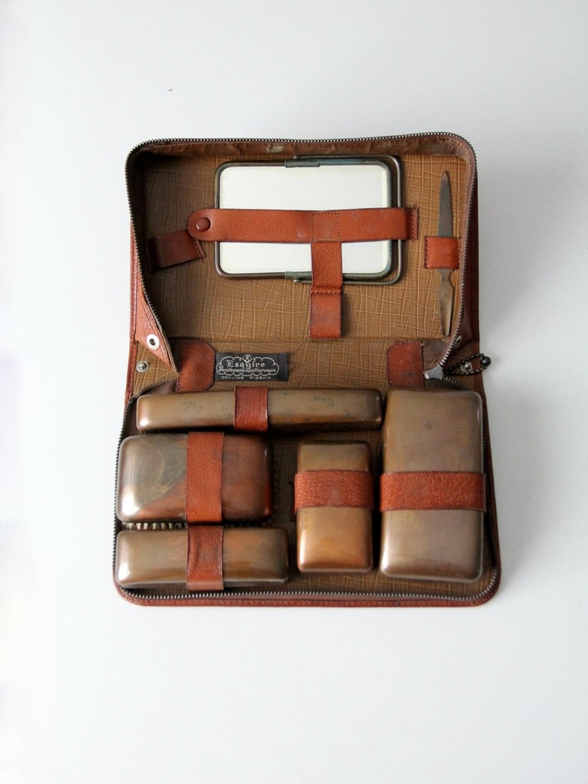 Vintage Esquire 1930s Dopp Kit Pigskin with Copper Interior: Vintage Esquire 1930s Dopp Kit Pigskin with Copper Interior Discover a piece of history with this Vintage Esquire Dopp Kit from the 1930s. Crafted from pigskin, this travel case showcases a beautiful 