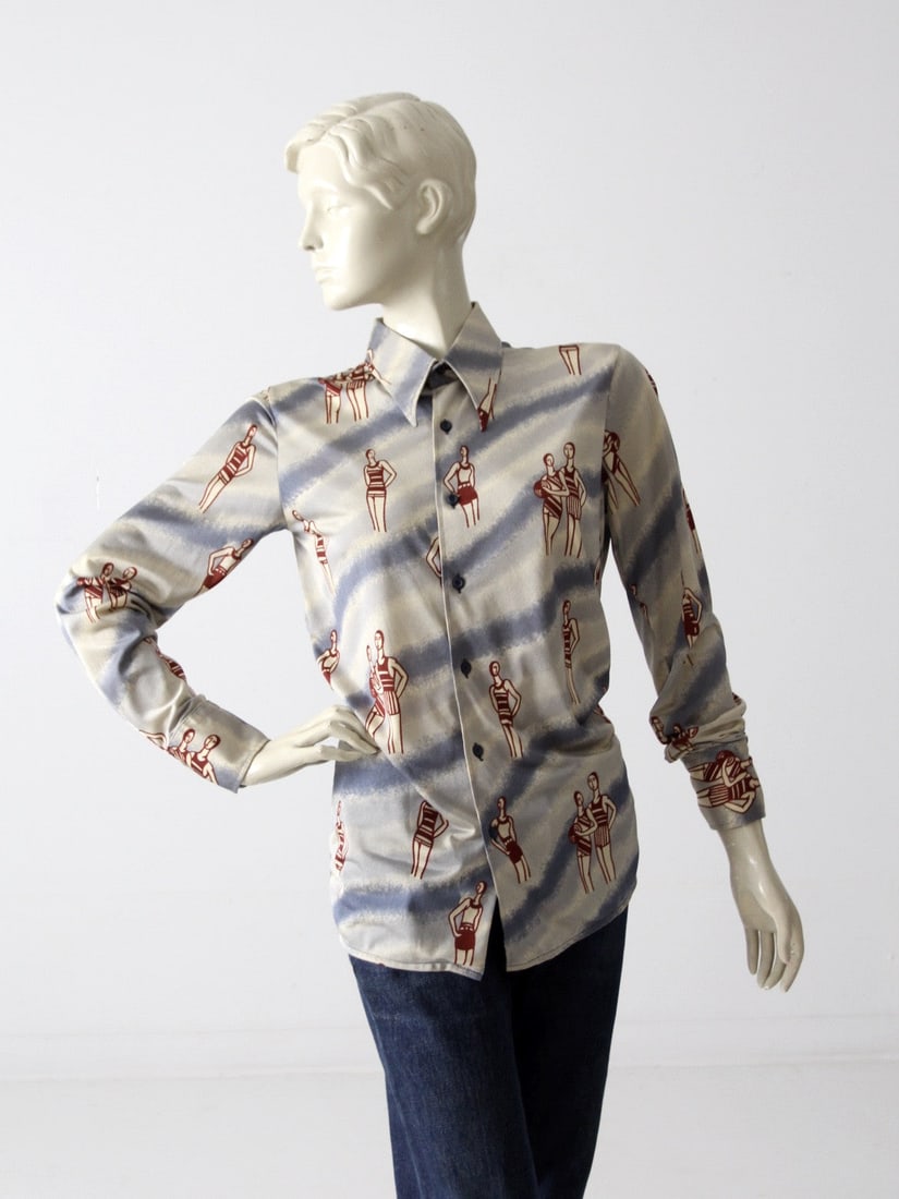 1970s Vintage Italian Nylon Button-Down Shirt Beach Bathers Print: 1970s Vintage Italian Nylon Button-Down Shirt Beach Bathers Print Step back into the vibrant style of the 1970s with this vintage Italian nylon shirt. Crafted from 100% texturized nylon, this fitted b