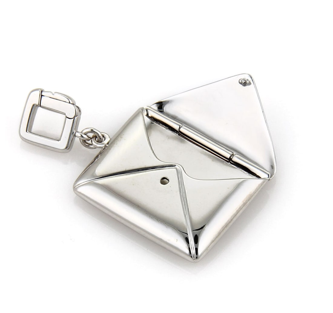 Louis Vuitton Envelope Charm Pendant in 18k White Gold: Louis Vuitton Envelope Charm Pendant in 18k White Gold A pre-owned Louis Vuitton envelope charm pendant crafted in solid 18k white gold with a polished finish. The dimensional envelope motif features 