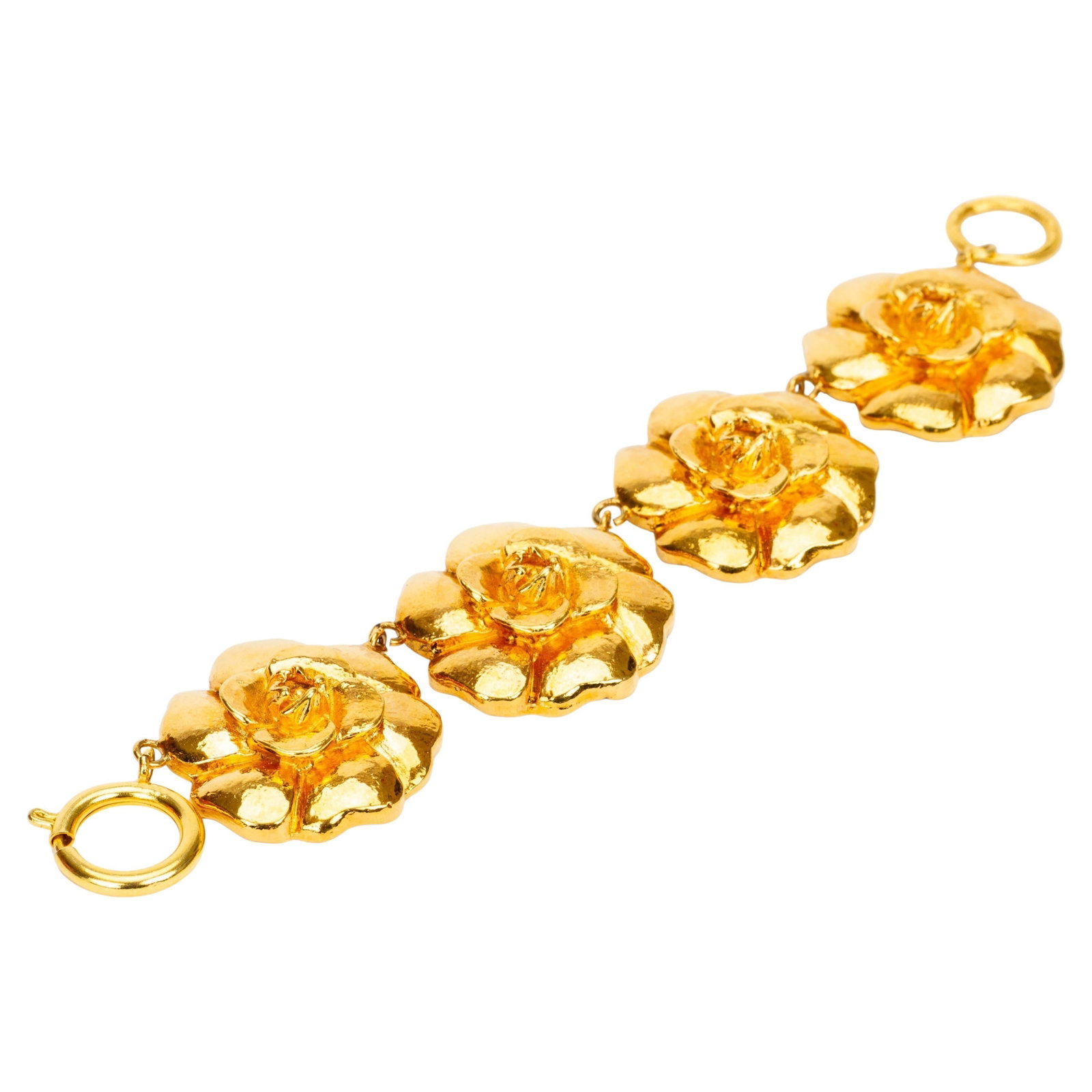 Chanel Gold Plate Camellia Flower Bracelet 7 in: Chanel Gold Plate Camellia Flower Bracelet 7 in This vintage Chanel bracelet from the 1970s showcases striking camellia flower motifs, each finished in gold plate. Crafted in France, the bracelet feat