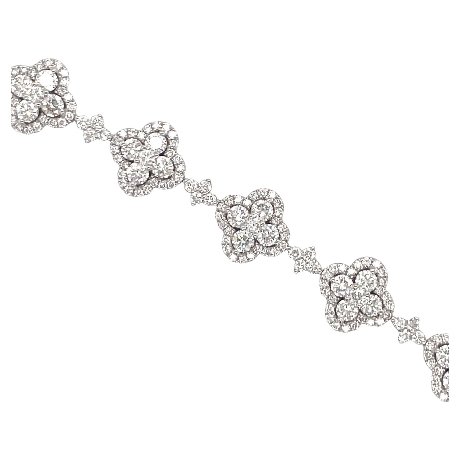 Harbor Diamonds 18K White Gold Diamond Floral Tennis Bracelet 6.55 Carats: Harbor Diamonds 18K White Gold Diamond Floral Tennis Bracelet 6.55 Carats This exquisite 18 Karat White Gold Diamond Floral Tennis Bracelet showcases a stunning design with 11 diamond flowers, each su