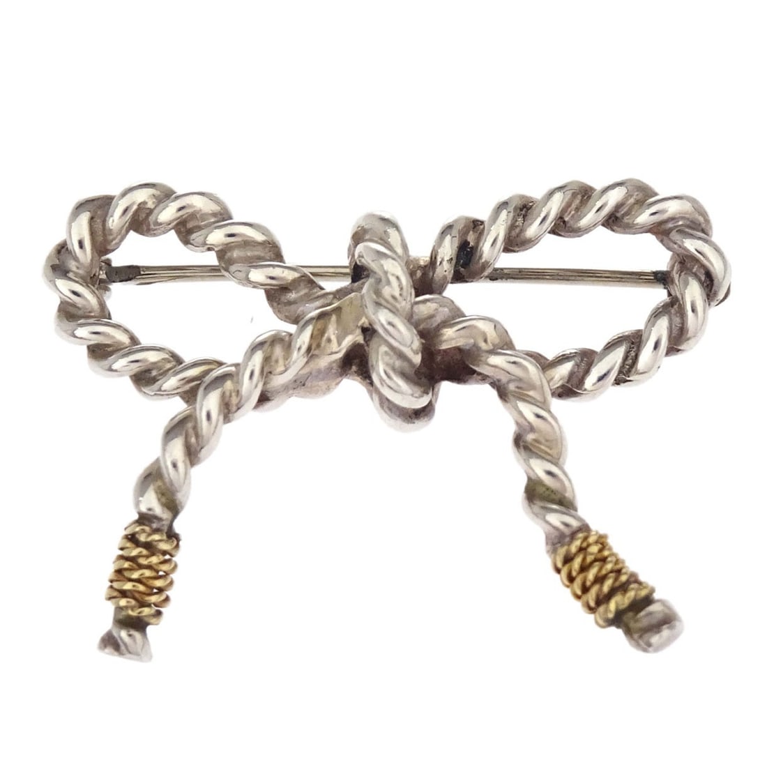 Tiffany & Co. Twist Bow Brooch Pin in SV925 and Au750: Tiffany & Co. Twist Bow Brooch Pin in SV925 and Au750 Silver and gold Tiffany & Co. brooch pin with a twist bow design. Made from SV925 and Au750, it is described as being in good condition with rust 