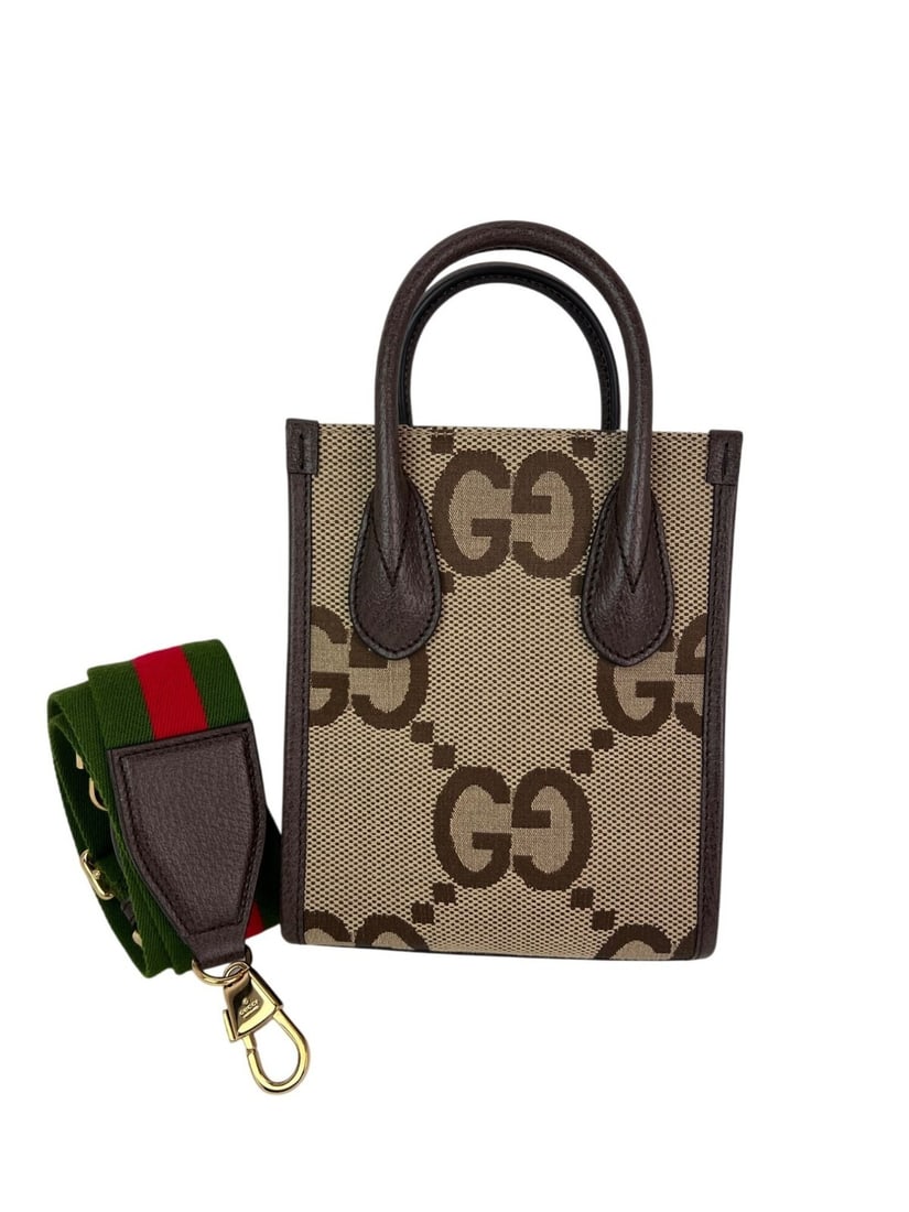 Gucci Jumbo GG Mini Web Vertical Tote Brown Calfskin with Gold Accents: Gucci Jumbo GG Mini Web Vertical Tote Brown Calfskin with Gold Accents Introducing the Gucci Jumbo GG Textured Dollar Calfskin Mini Web Vertical Tote, a stylish and versatile accessory ideal for casua