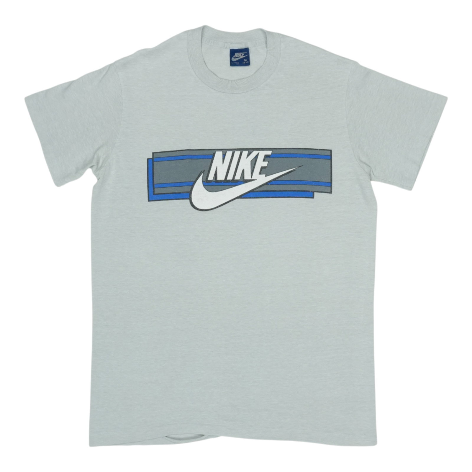 Vintage 1980s Grey Nike Poly Cotton Medium Shirt: Vintage 1980s Grey Nike Poly Cotton Medium Shirt This is an original vintage Nike shirt from the 1980s, featuring a classic grey color and constructed from a 50/50 polyester and cotton blend. The shir
