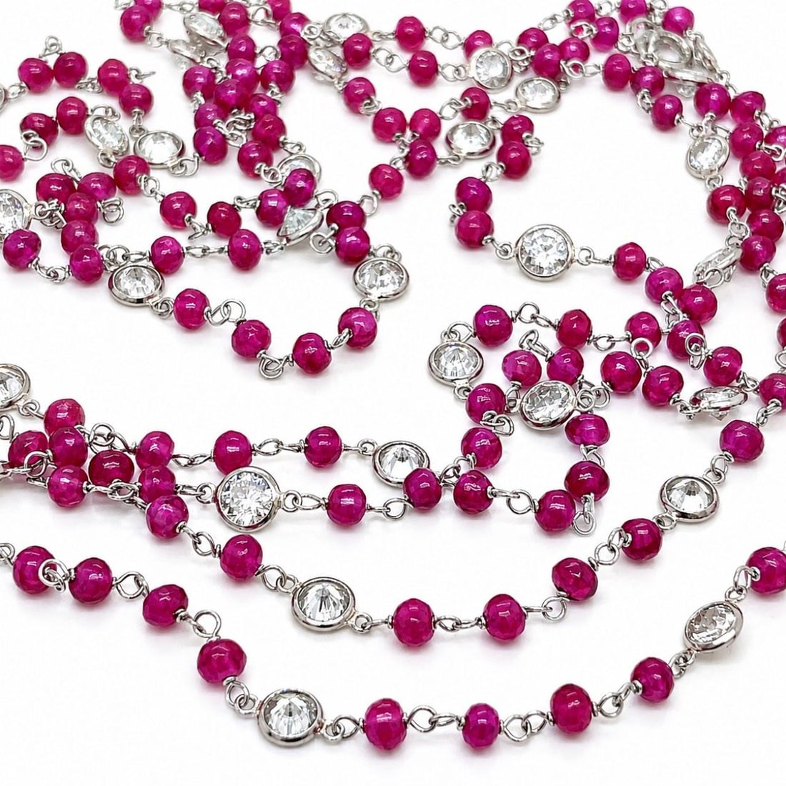 Platinum 52 Inch Necklace with Rubies and European Cut Diamonds: Platinum 52 Inch Necklace with Rubies and European Cut Diamonds Platinum by the yard necklace set with rubies and European-cut diamonds. The necklace weighs 20.4 grams and measures 52 inches in length