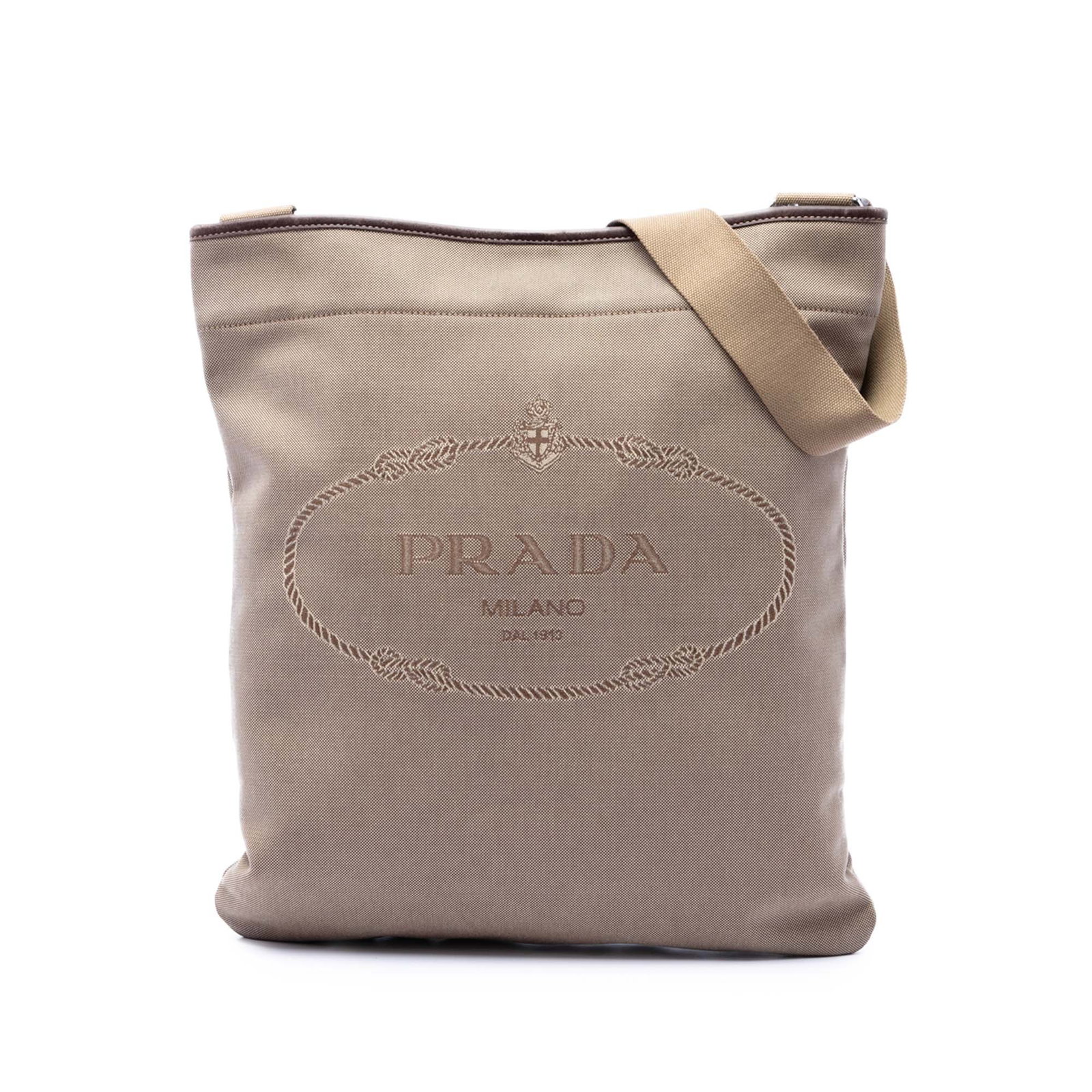 Prada Canapa Logo Canvas Crossbody Bag with Leather Trim: Prada Canapa Logo Canvas Crossbody Bag with Leather Trim Prada Canvas Canapa Logo Messenger Bag in beige fabric with leather trim. This crossbody style features an adjustable flat strap with a leather