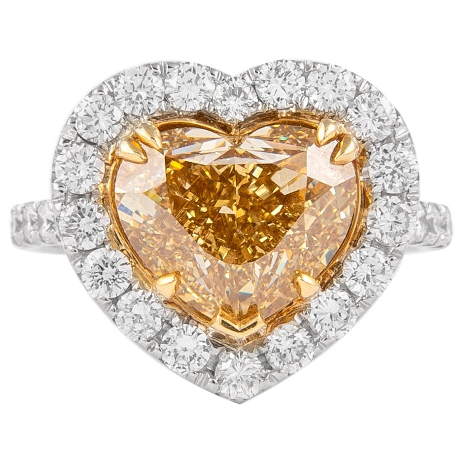 GIA 5.01 Carat Heart Champagne Yellow Diamond Ring in 18k Gold: GIA 5.01 Carat Heart Champagne Yellow Diamond Ring in 18k Gold This exquisite ring features a stunning champagne yellow diamond at its center, weighing 5.01 carats and certified by GIA. The diamond is