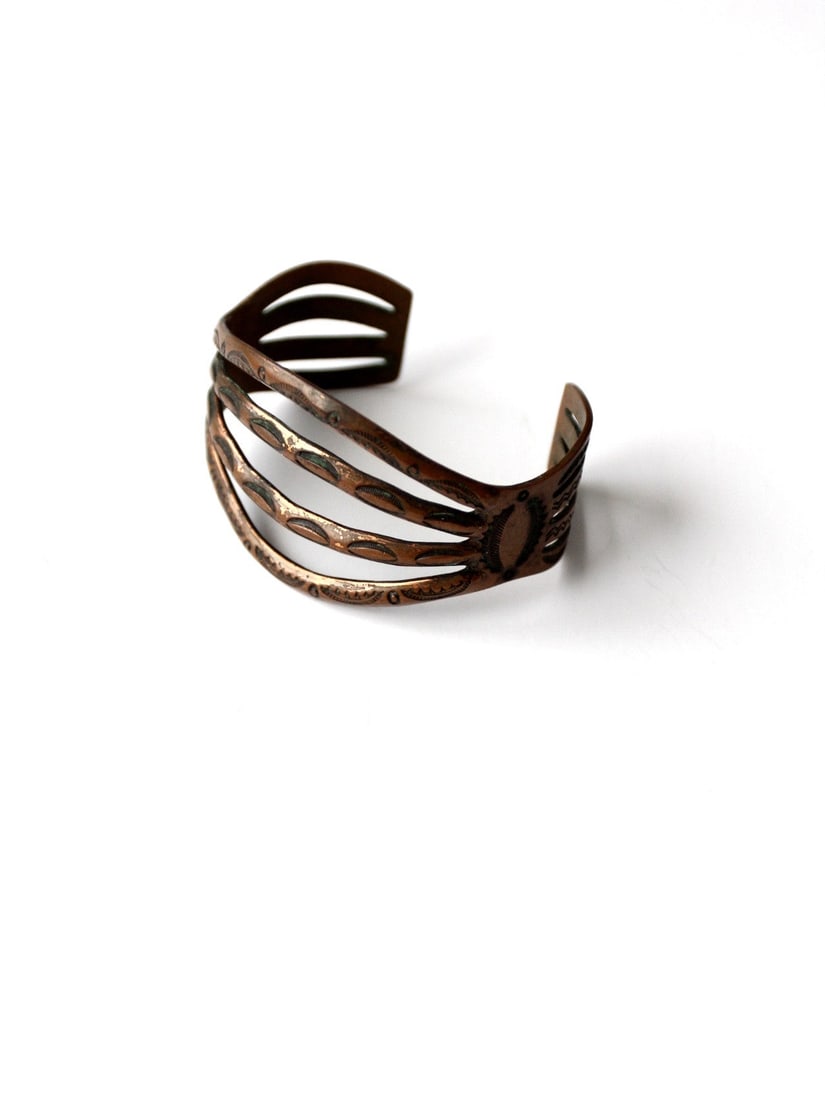 1970s Vintage Copper Cuff Bracelet with Southwest Design: 1970s Vintage Copper Cuff Bracelet with Southwest Design Discover timeless style with this Vintage 1970s Copper Cuff bracelet. Crafted with an etched design, this wide band cuff features a unique four