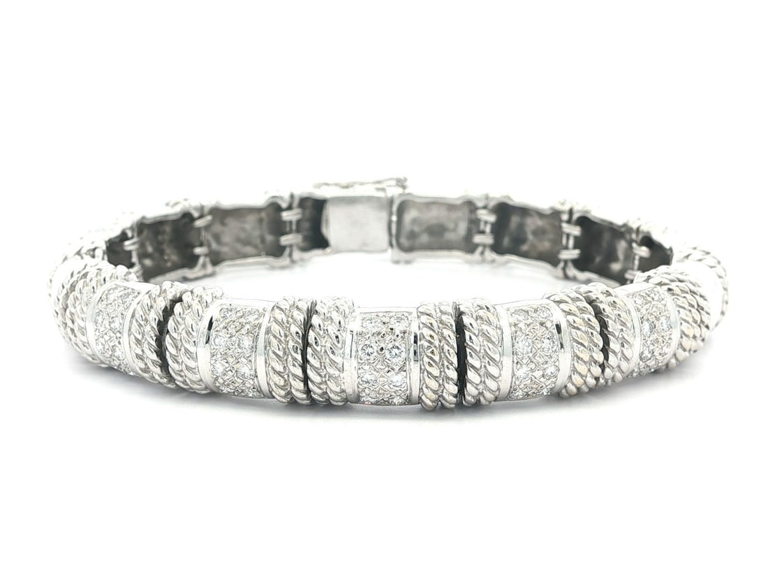 Cassis 18k White Gold Diamond Twisted Wire Bracelet 0.40ctw: Cassis 18k White Gold Diamond Twisted Wire Bracelet 0.40ctw This exquisite bracelet features a stunning design crafted from solid 18k white gold, showcasing (40) natural genuine diamonds. The diamonds