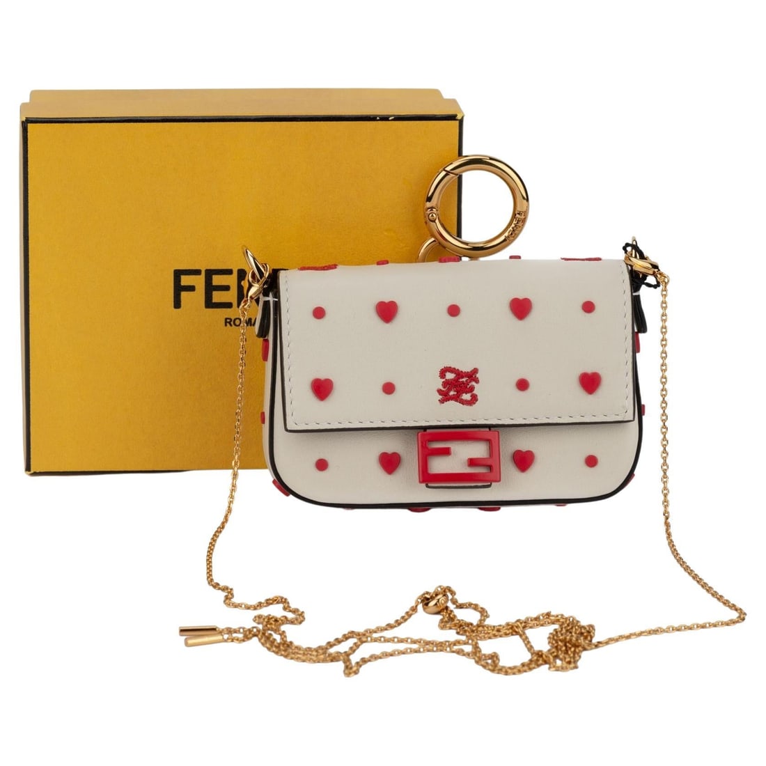 Fendi Nano Baguette White Leather Red Hearts Charm Bag: Fendi Nano Baguette White Leather Red Hearts Charm Bag Fendi nano baguette in white leather with a red hearts design and gold tone hardware. This compact bag features a front flap closure, a detachabl