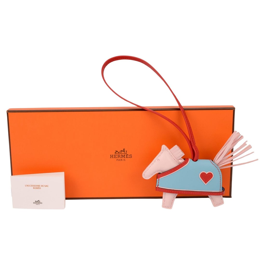 Hermes Coeur PM Rodeo Robeo Heart Charm in Multicolor Lambskin Leather: Hermes Coeur PM Rodeo Robeo Heart Charm in Multicolor Lambskin Leather Hermes Rodeo Robeo Coeur PM charm crafted from milo lambskin leather in Rose Darling, Bleu Celeste, and Rouge Radieux. Includes o