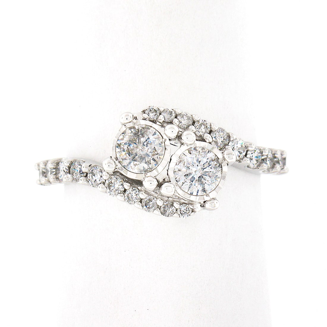 10K White Gold 1ctw Dual Bypass Diamond Ring with Accents: 10K White Gold 1ctw Dual Bypass Diamond Ring with Accents This stunning bypass ring showcases the elegance of solid 10k white gold, featuring a total diamond weight of approximately 1.00 carats. The c