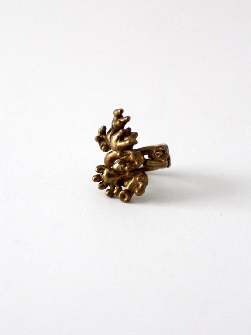 Hand-Crafted Vintage Brutalist Brass Ring Size 5.5: Hand-Crafted Vintage Brutalist Brass Ring Size 5.5 This vintage brutalist ring showcases a unique hand-crafted design in brass, reflecting the modernist style. The piece features a beautiful patina th
