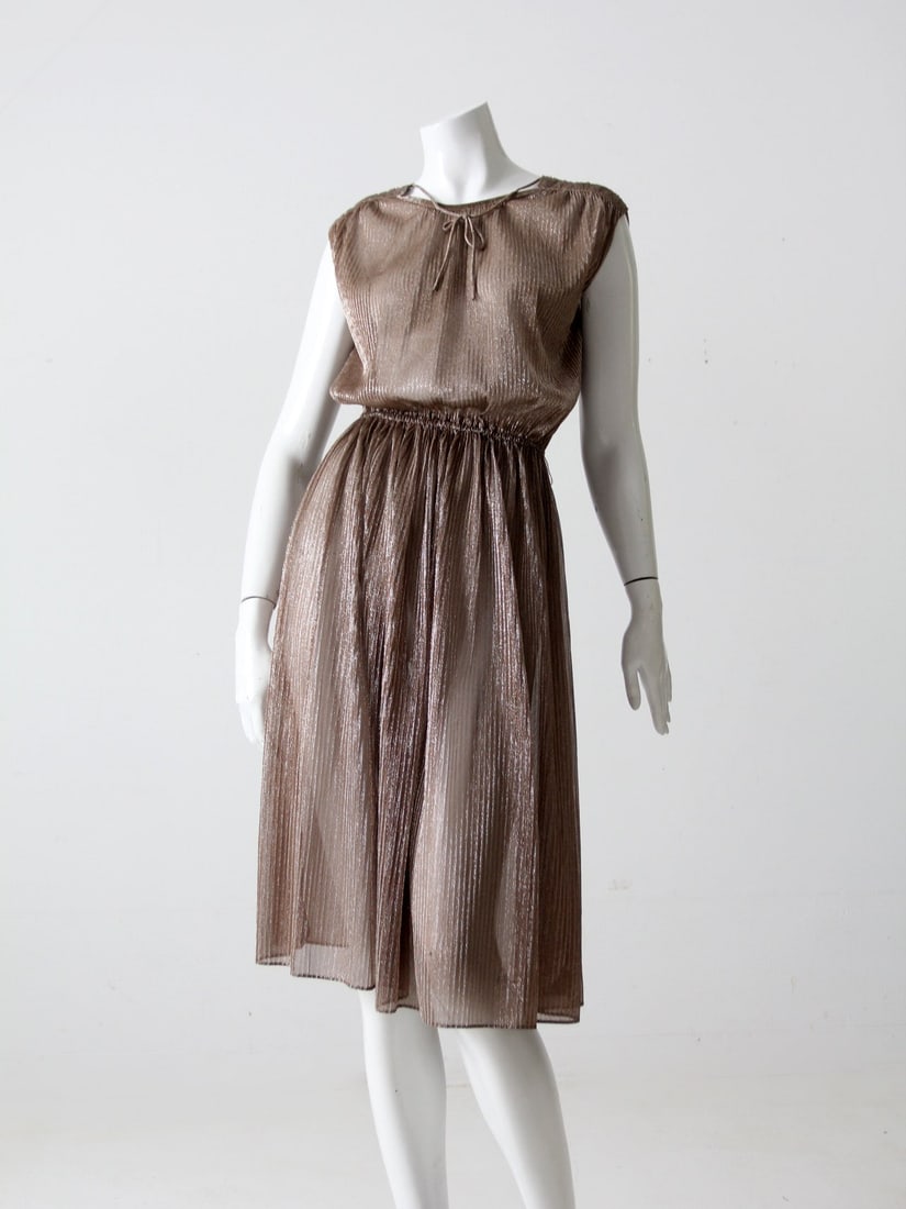 1970s Infinity Grecian Metallic Dress Bronze Sleeveless: 1970s Infinity Grecian Metallic Dress Bronze Sleeveless Step back in time with this stunning 1970s vintage metallic dress by Infinity. This Grecian-inspired piece showcases a shimmering bronze fabric 